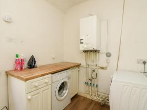 a laundry room with a washing machine and a washer at Mars Hill Upper in Dunoon