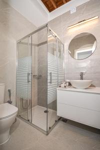 a bathroom with a shower and a sink and a toilet at Villa Danae - Lindos in Líndos