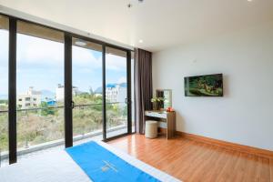 a bedroom with a large window with a view at Havana Con Dao Hotel in Con Dao