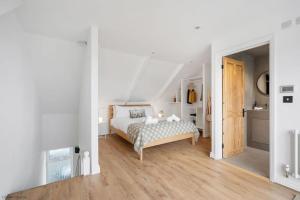 a white bedroom with a bed and a hallway at Stylish & Modern Home, Central Newquay w/parking in Newquay