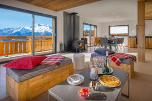 a living room with a view of a mountain at Chalet Paralpin - OVO Network in Manigod