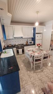 a kitchen with a table and a sink at Vasiliki's guest house in Vergia