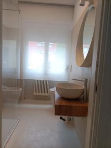 W łazience znajduje się umywalka i lustro. w obiekcie Gardasee apartment w mieście Riva del Garda