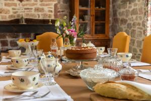 a table with a cake on top of it at La Demeure du Comte in Marcillac-Vallon