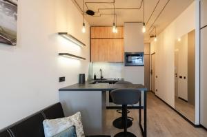 a kitchen with a counter and a bar in a room at 26305 New smart studio in RC Manhattan City in Kyiv