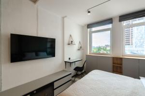 a bedroom with a bed and a flat screen tv at 26305 New smart studio in RC Manhattan City in Kyiv
