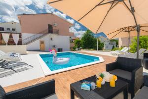 a pool with a swan in the middle of a house at Oleander in Malinska