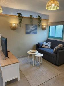 a living room with a couch and a table at heart of the golan heights cabin -בקתה במטע in Eli Ad