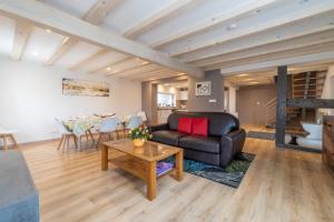 a living room with a couch and a table at Maison Florentine in Gunstett