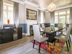 a dining room with a table and chairs and a fireplace at The Hideaway in Brighton & Hove