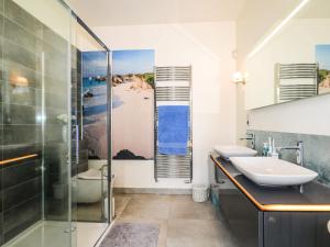 a bathroom with a glass shower and a sink at The Hideaway in Brighton & Hove