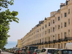 a row of buildings on a street with cars parked at The Hideaway in Brighton & Hove