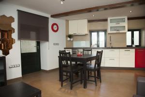 a kitchen with a table and chairs in a room at Apartment Hortas in Santiago de Compostela