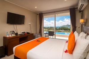 a hotel room with a bed with a view of a pool at The Ridge Residence in Victoria