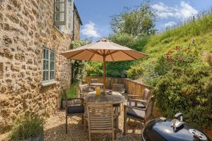 a table with an umbrella next to a building at The Old Chapel in Beaminster