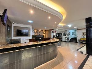 a lobby with a bar in a hotel at Hotel Bons Tempos in Rio Verde