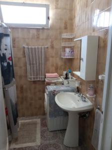 a bathroom with a sink and a toilet at Pergola in Matino