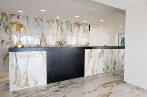 a lobby with a marble counter with a trophy on it at Mythical Coast Wellness Retreat in Mytilini