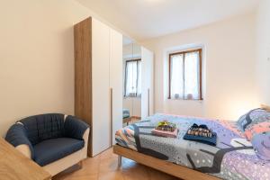 a bedroom with a bed and a chair at Via del Casentino in Reggello