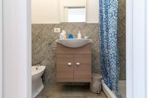 a bathroom with a sink and a toilet at Via del Casentino in Reggello