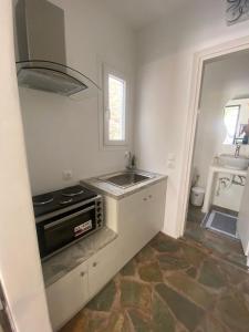 a kitchen with a sink and a stove at Simousi Studio 1, On the Beach! Kythnos in Kithnos