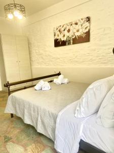 a hotel room with two beds with towels on them at Simousi Studio 1, On the Beach! Kythnos in Kithnos