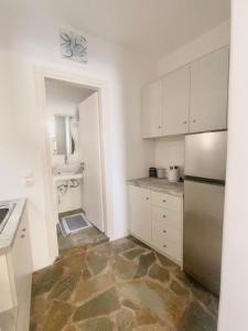 a kitchen with a refrigerator and a sink at Simousi Studio 1, On the Beach! Kythnos in Kithnos