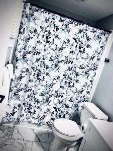 a bathroom with a black and white shower curtain at Modern Room 12-Newly Renovated in Roscommon