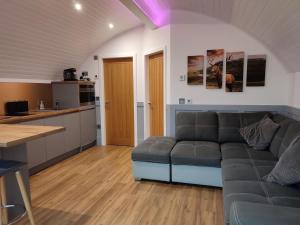 a living room with a couch and a kitchen at Knockan in Keith