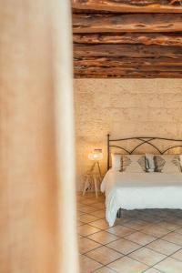 a bedroom with a bed and a wooden ceiling at Finca Norte, Amazing villa close to the best Beaches in Portinatx