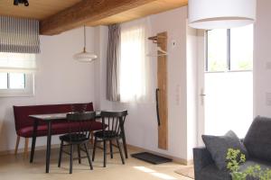 a living room with a dining room table and chairs at Ferienhaus Alwine in Jork