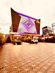 a large building with a purple light on it at Hotel The Onix in Dehradun