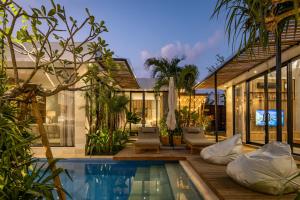 an exterior view of a house with a swimming pool at Ananda Villa by Betterplace in Jimbaran