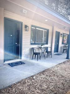 a patio with chairs and a table in front of a house at TeePee Room 9-Newly Renovated in Roscommon +18 photos