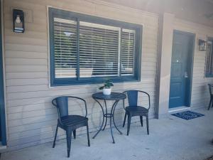 a table and chairs on a porch with a window at TeePee Room 9-Newly Renovated in Roscommon