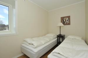 a white room with a couch and a window at Geilo Gaarden in Geilo