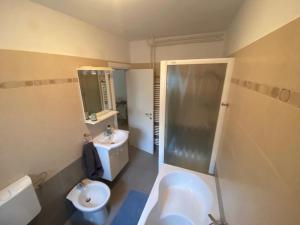 a bathroom with a sink and a shower and a toilet at Klementina in Mali Lošinj +18 photos