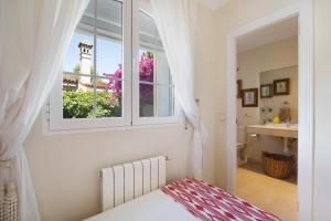 a bedroom with a window and a bathroom with a sink at Olmo tree in Vista Hermosa +37 photos