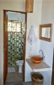 a bathroom with a wooden sink and a toilet at Fazenda Bom Sossego - Corumbau, BA in Corumbau