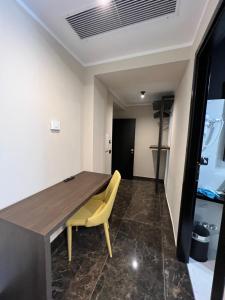 a dining room with a wooden table and yellow chair at Viminale Domus in Rome