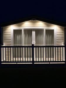a house with a balcony at night with lights at Highland Holiday Getaways in Embo
