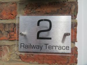a sign on a brick wall that reads railway terrace at 2 Railway Terrace 