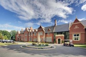 a large red brick building with a car parked in front at 2 Railway Terrace in Croft