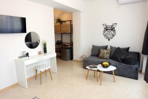 a living room with a couch and a table at Old Town Hall Suites and Apartments in Athens