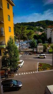 a car parked on a street next to a yellow building at Alloggio Rumore di Onde in Rapallo