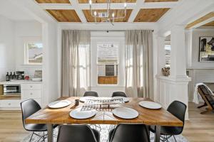 a dining room with a wooden table and chairs at Urban Elegance Retreat in San Antonio