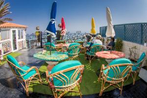 a group of chairs and tables and umbrellas on a patio at Skyrock Dahab in Dahab