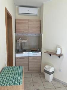 a small kitchen with a sink and a stove at Apartmani Fani 2 min walking from sea in Orebić +32 photos