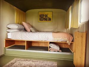 a bedroom with a bed in a tiny house at Renison's Farm in Penrith