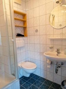 łazienka z toaletą i umywalką w obiekcie Matheishof w mieście Ruhpolding